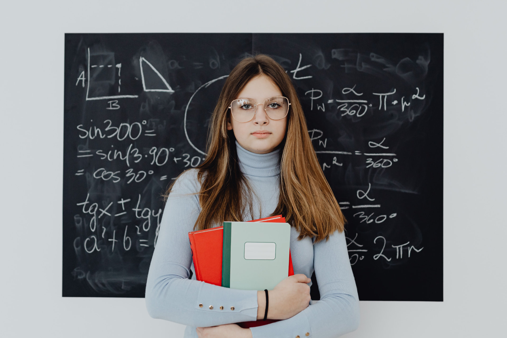 Student solving geometry problems, photographed with direct flash